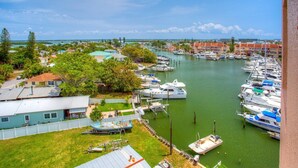 A marina with boats docked, surrounded by residential buildings and greenery.