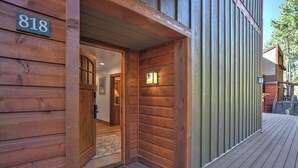 A wooden exterior with a number sign, a wooden door, and a wooden deck. - Whistle Stop | AC, Pool, Hot Tub, Golf & Ski (Durango)