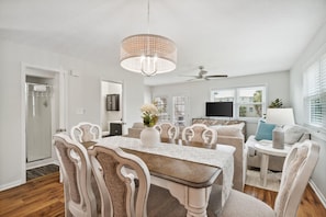 Relax in this spacious living area with a large dining table and comfortable seating for meals and socializing.