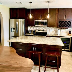 Enjoy cooking in this well-equipped kitchen with a large island and bar stools.
