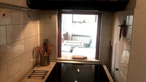 A kitchen with a built-in stovetop, a window, and a utensil holder. - 4stars FRENCH EMBASSY One Bedroom Apartment, AMZEI historic downtown, very quiet (Bucharest)