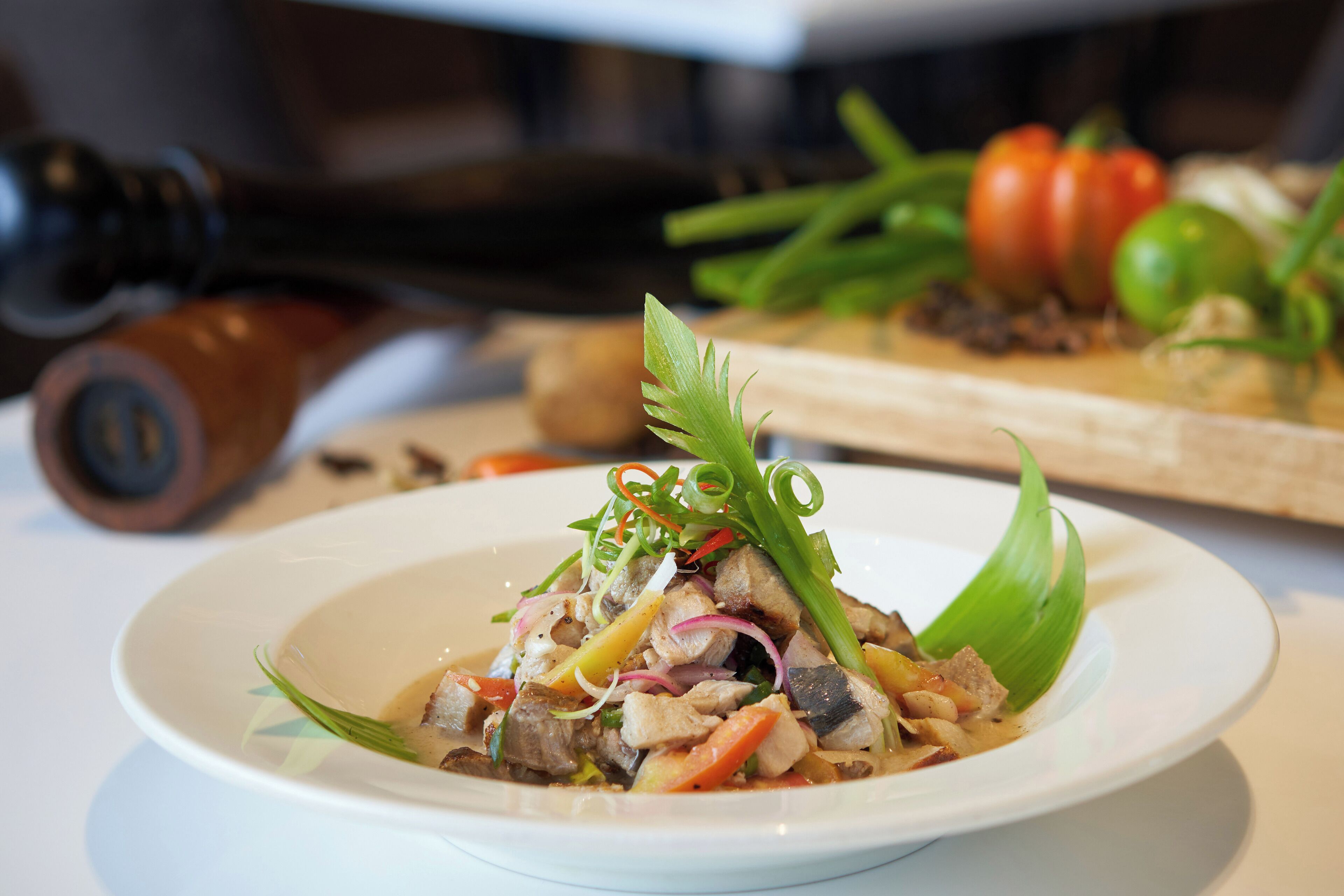 A plate of food with various ingredients and garnishes.