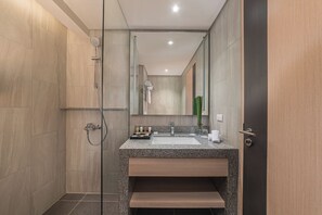 A modern bathroom with a shower, sink, and mirror. - Seda Central Bloc Cebu City (Cebu City)