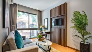 Deluxe Apartment | Living room | 32-inch flat-screen TV with digital channels, TV, Netflix - The Art - Sunshine Apartment (Ho Chi Minh City)