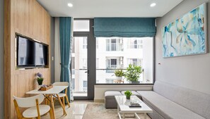 Business Apartment | Living room | 32-inch flat-screen TV with digital channels, TV, Netflix - The Art - Sunshine Apartment (Ho Chi Minh City)