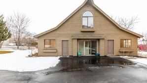 A house with a gabled roof, a front door, and a garage door.