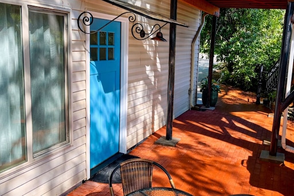 Private fenced patio with seating and grill