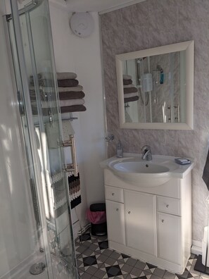 Shower, hair dryer, towels, soap