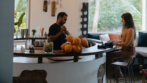 A cafe with a counter, a menu board, and a large window with a view of trees. - Kirinuga Boutique Retreat (Tangalle)
