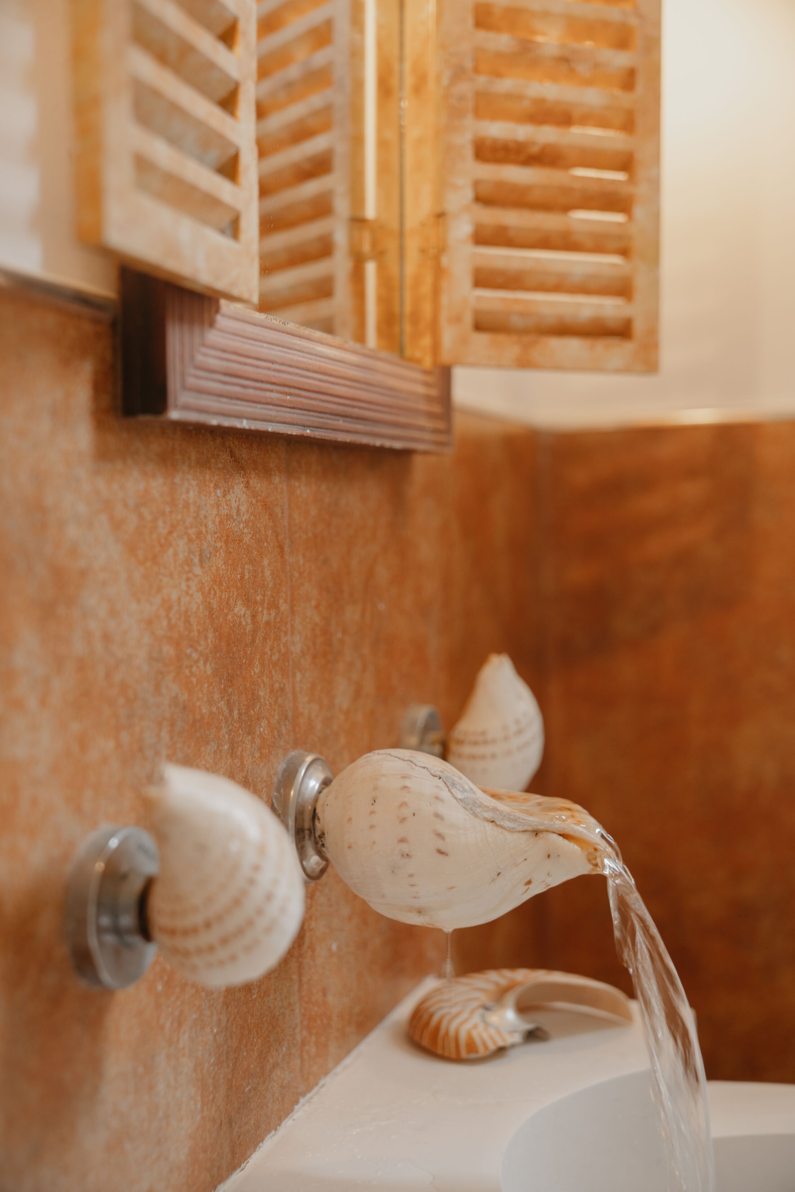 A bathroom with a wooden vanity, a sink, and a shower.