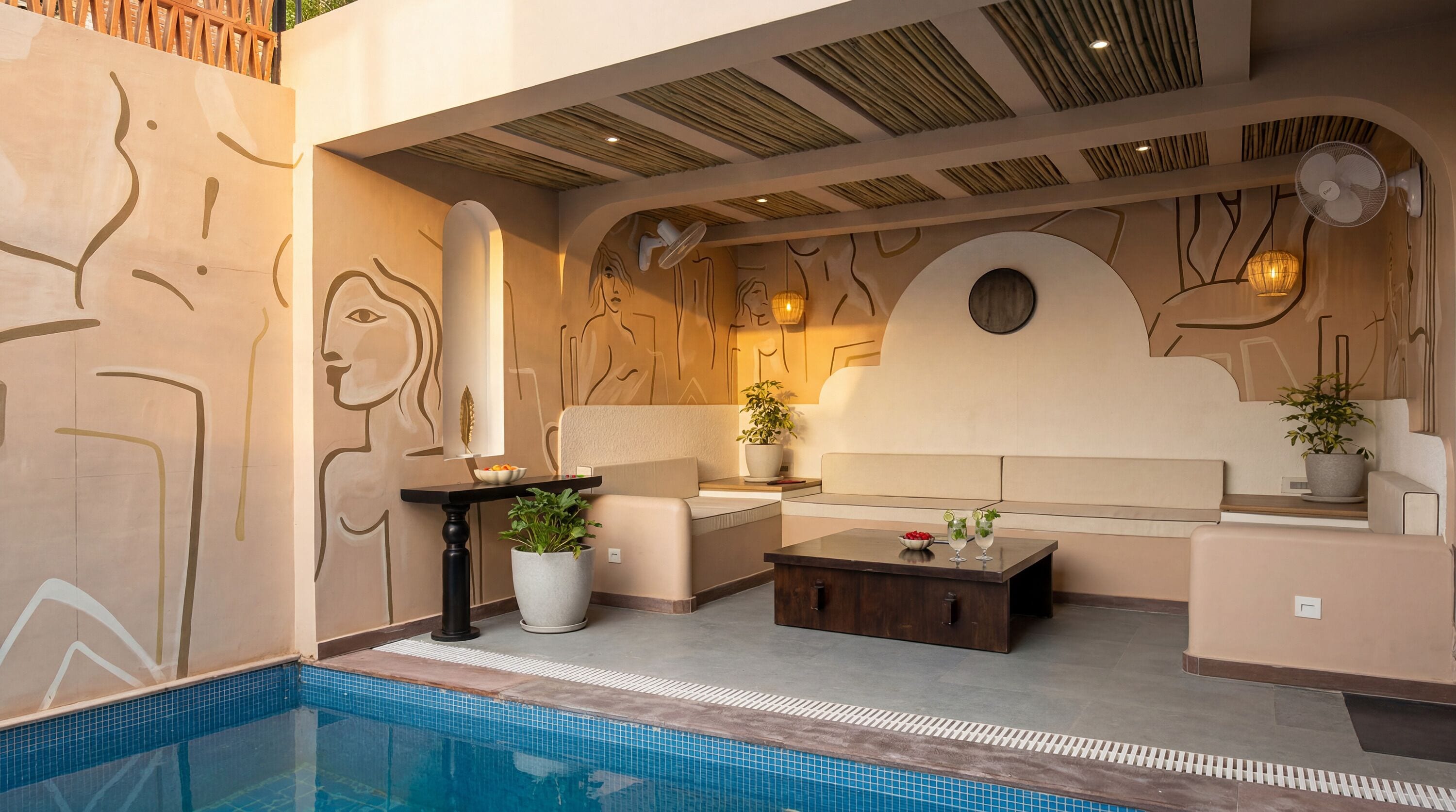 A modern indoor pool area with a lounge, seating, and a decorative wall.