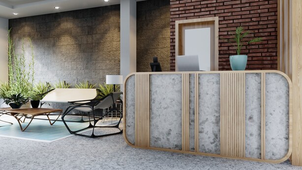 Un espace d’accueil moderne avec un mur en pierre, un comptoir d’accueil, un coin salon avec une table et des chaises, et des plantes en pot.