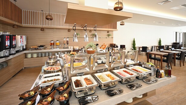 A buffet with various food stations and seating areas in a modern hotel setting. - Hotel Maruya Grande (Minamisoma)