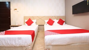A hotel room with two beds, each with red and white bedding, a wooden headboard, and a flat-screen TV mounted on the wall. - Super OYO 89771 Dane & Shue (Kota Bharu)