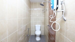 A small, tiled bathroom with a toilet, a showerhead, and a handheld shower unit. - Super OYO 89771 Dane & Shue (Kota Bharu)