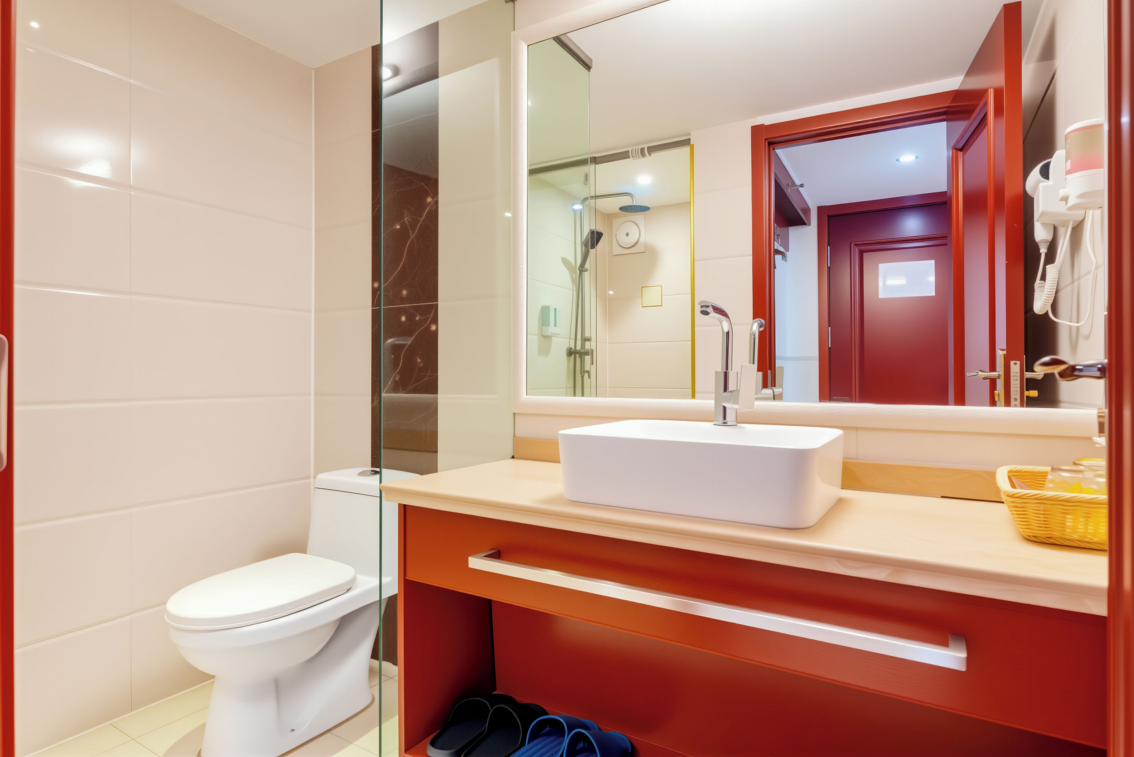 A modern bathroom with a toilet, shower, and sink.