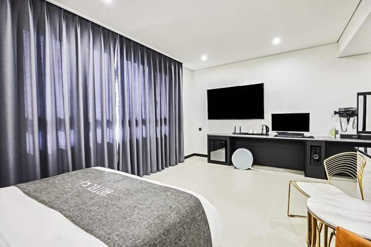 Premium bedding, down comforters, memory foam beds, laptop workspace