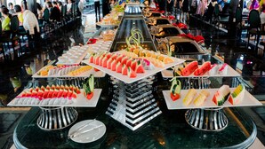 A buffet with various food items arranged on multiple serving platters. - Rita Cruise (Tuan Chau)