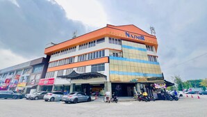 A multi-story hotel with a prominent orange and white facade, featuring a large sign for "Golden Nasmir Hotel". - Golden Nasmir Hotel (Perai)
