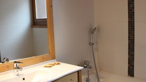 A bathroom with a sink, mirror, and shower. - <<<<>>>> (Les Gets)