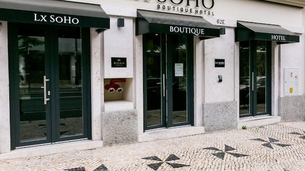 A building with three entrances labeled "LX SOHO BOUTIQUE HOTEL," "LX SOHO," and "HOTEL." - Lx SoHo Boutique Hotel by RIDAN Hotels (Lisbon)
