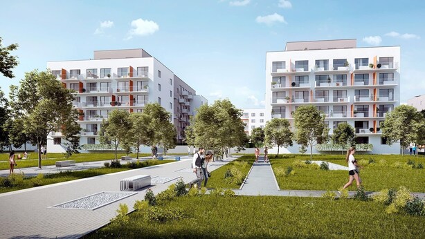 A modern residential complex with multi-story buildings, outdoor walking paths, and green spaces.