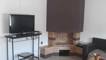 Apartment, 1 Bedroom | Living area | 32-inch flat-screen TV with satellite channels, TV