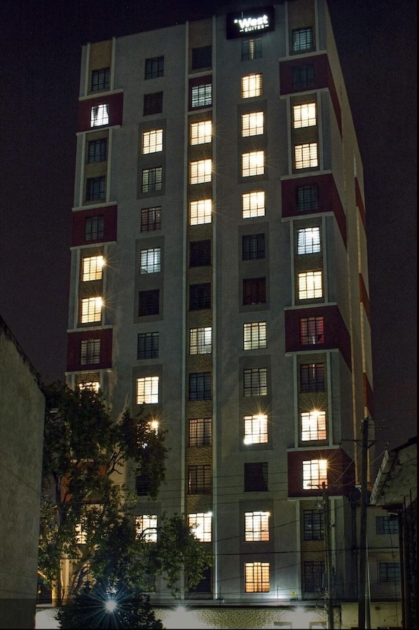 Experience the vibrant atmosphere of this urban hotel, where modern rooms and suites shine with illuminated windows.