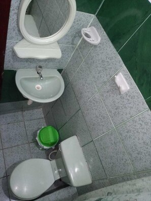 A bathroom with a toilet, sink, and bidet.
