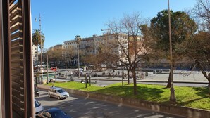 A street view with a building, cars, and a park area. - Stefano House Roma (Rome)