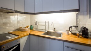 Uma cozinha moderna com pia de aço inoxidável, cafeteira e torradeira.
