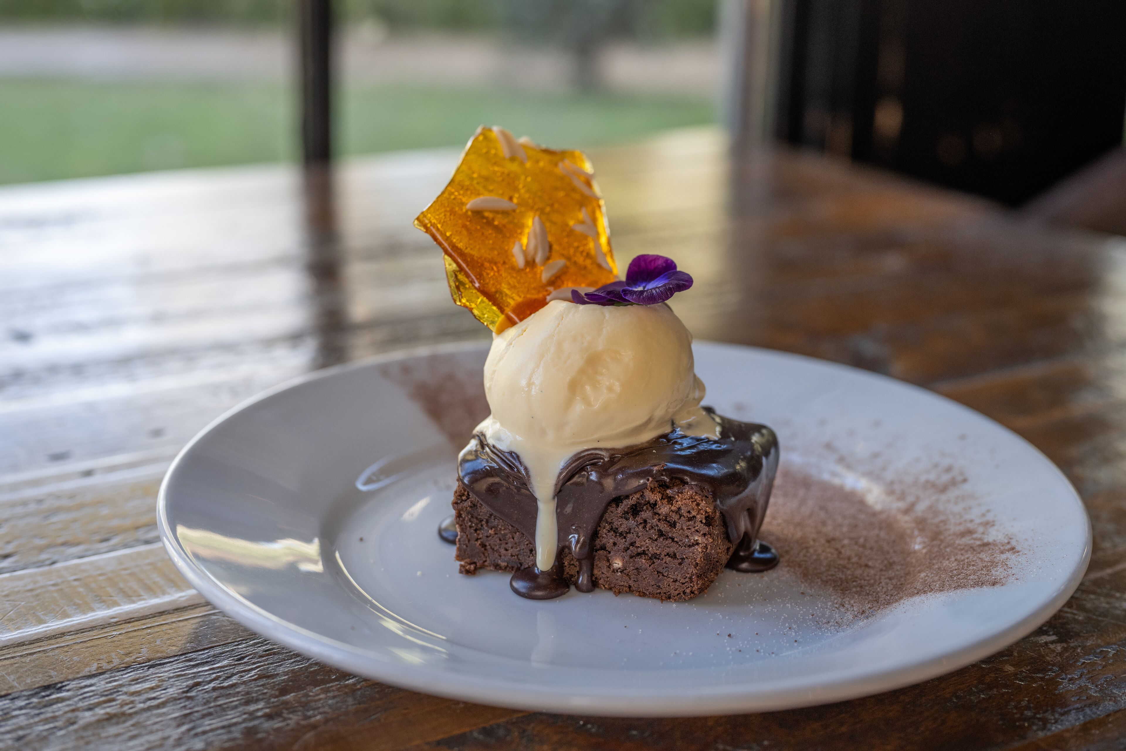 A dessert on a white plate with a wooden table background.
