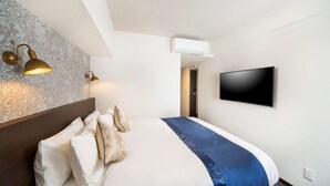 A hotel room with a large bed, a flat-screen TV mounted on the wall, and an air conditioning unit above the bed. - Best Western Hotel Fino Shin-Yokohama (Yokohama)