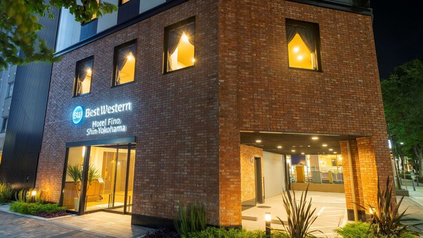 A hotel with a modern brick facade, illuminated windows, and a clear sign indicating it is the Best Western Hotel Fino Shin-Yokohama. - Best Western Hotel Fino Shin-Yokohama (Yokohama)