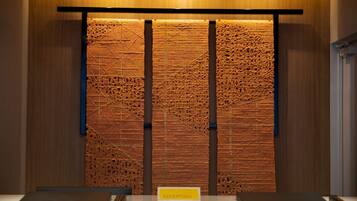 A reception area with a textured wall and a sign labeled "RECEPTION".