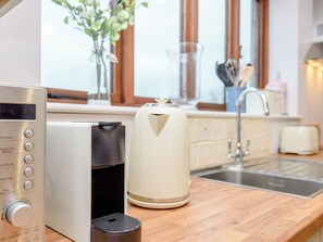 A kitchen with a coffee maker, a microwave, and a toaster on the counter.