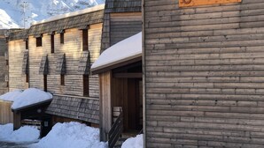 Un edificio de madera con un letrero que dice "SIRAC A" y una montaña nevada al fondo.