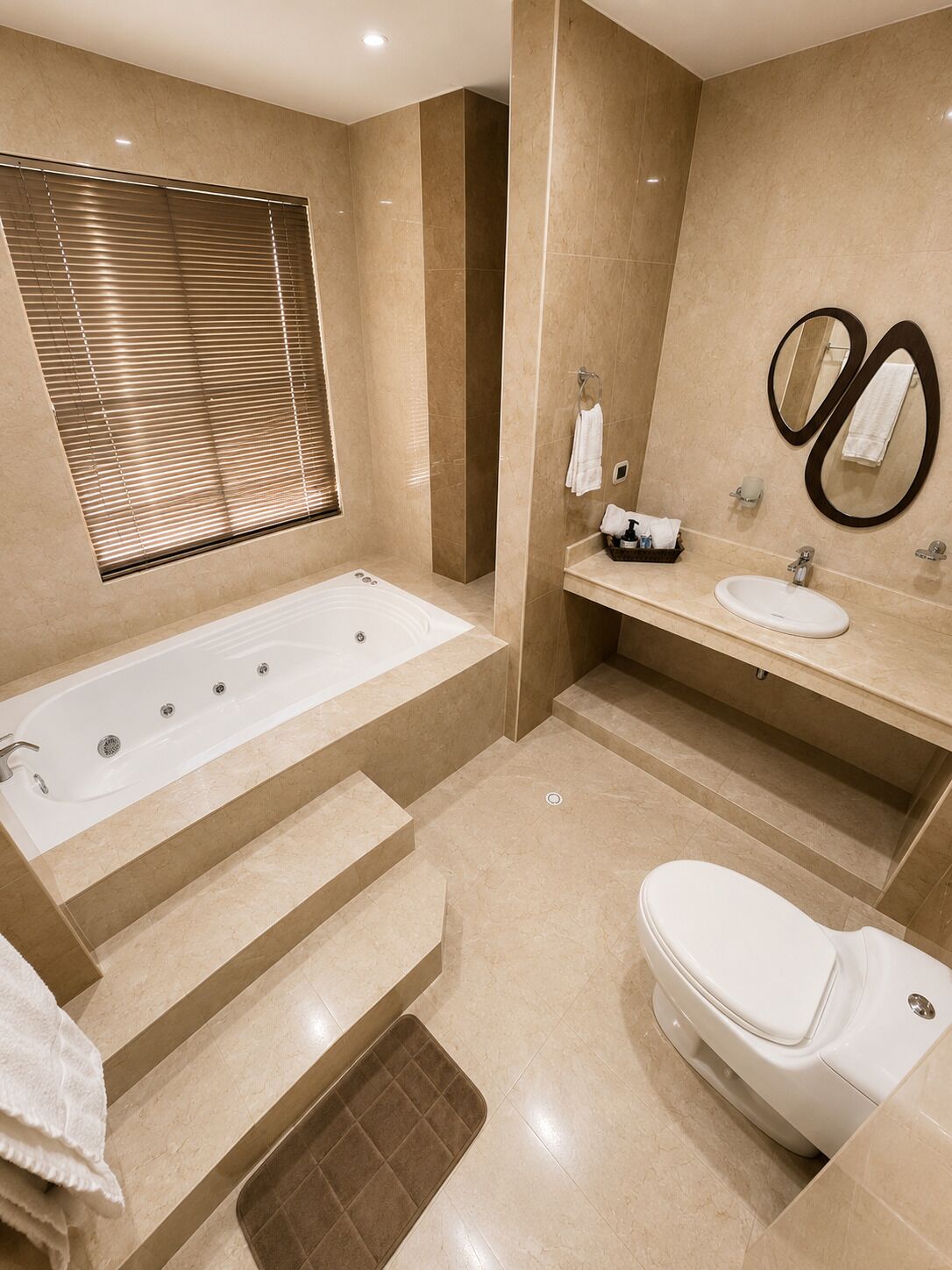 A modern bathroom with a bathtub, toilet, and sink.