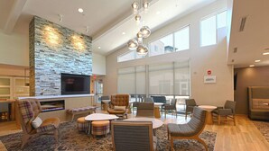 A spacious lobby with a stone accent wall, multiple seating areas, and large windows. - Residence Inn by Marriott Richmond West/Midlothian (Richmond)