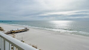 A beach with a pier and a lifeguard station.