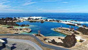 Une station balnéaire dotée de plusieurs piscines, entourée d’un paysage rocheux et donnant sur l’océan.