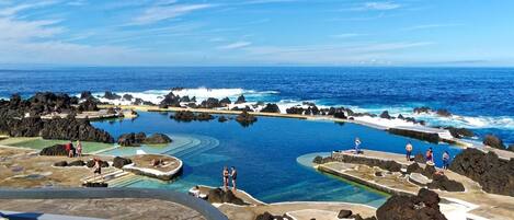 Una piscina al aire libre, una piscina climatizada