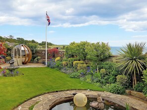 A garden with a pond, a flag, and a spherical structure. - Woodlands - Bridlington Links (Sewerby, near Bridlington)