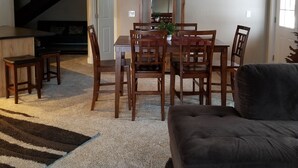 A dining area with a wooden table and chairs, a ceiling fan, and a large mirror above the table. - House - 3 BR - 2 BA - Sleeps 10
 (Yampa)