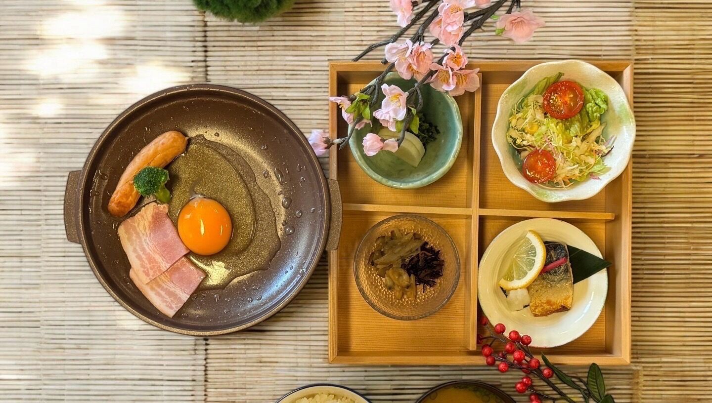 Una bandeja de madera con diversos platos, incluyendo un tazón de ensalada, un plato con pescado y un tazón de verduras encurtidas.