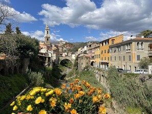 A historic town with a prominent clock tower, stone bridge, and colorful buildings. - Beautiful private villa for 5 guests with pool, TV, terrace and pets allowed (Dolcedo)