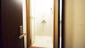A narrow doorway leading to a bathroom with a shower, a towel rack, and a toilet. - Start One Home Senzoku A (Tokyo)