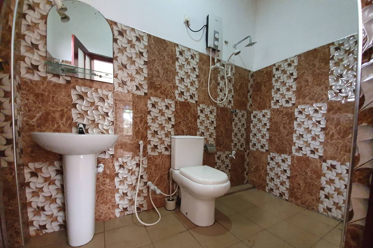 A bathroom with a sink, toilet, and shower.