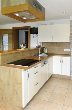 Enjoy cooking in this well-equipped kitchen with an oven, induction cooktop, and stainless steel sink.