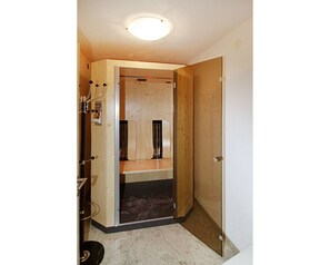 room with a wooden door and simple lighting.